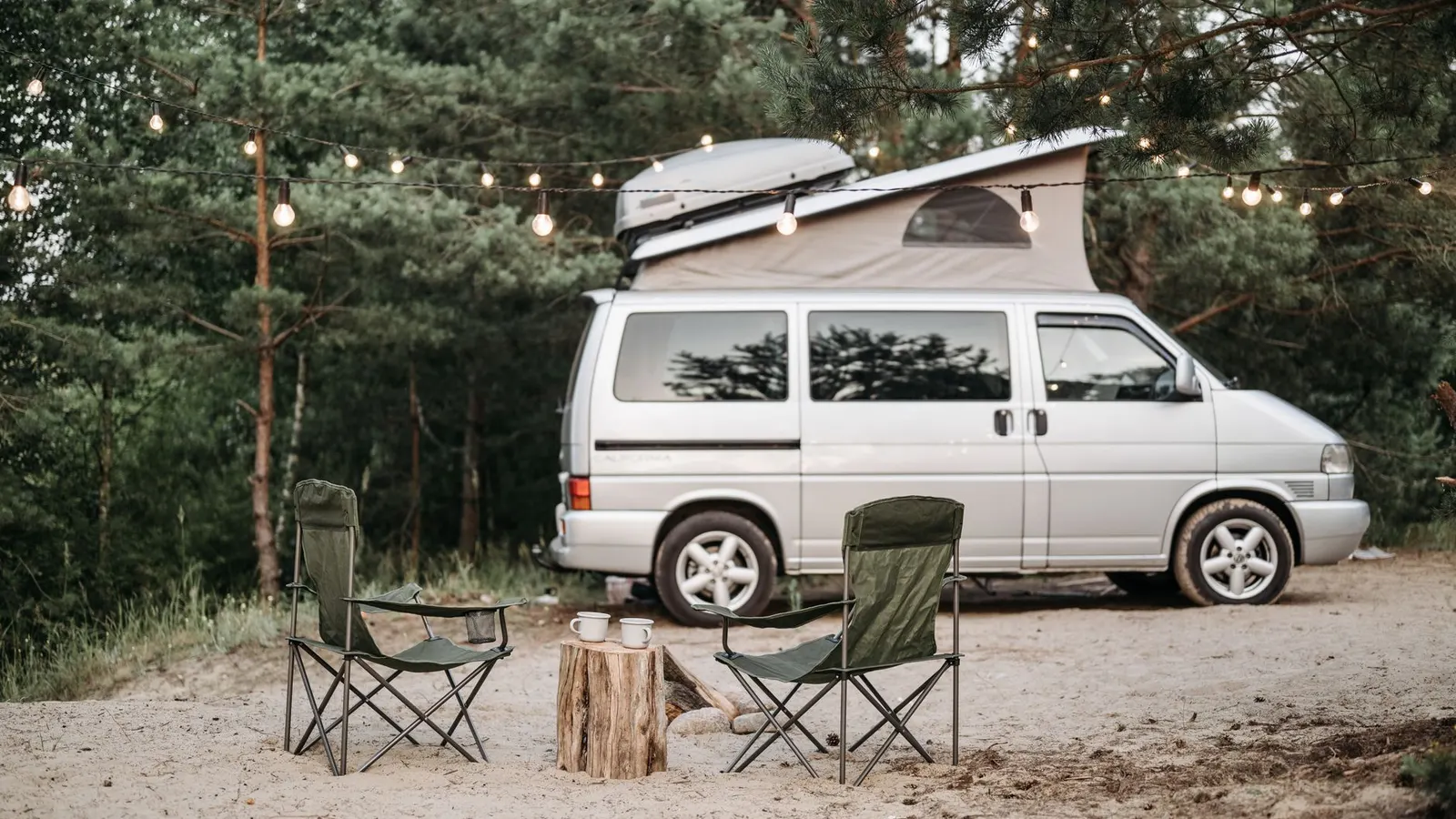 A camper van at a campsite in the evening
