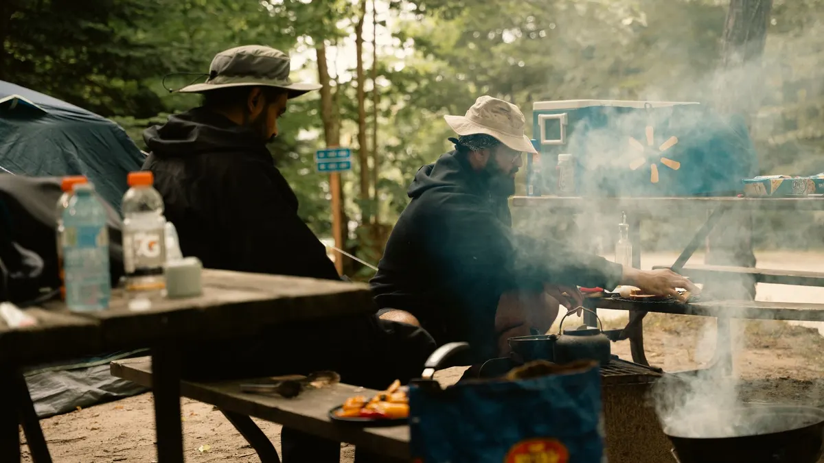 A laptop on a table at a campsite